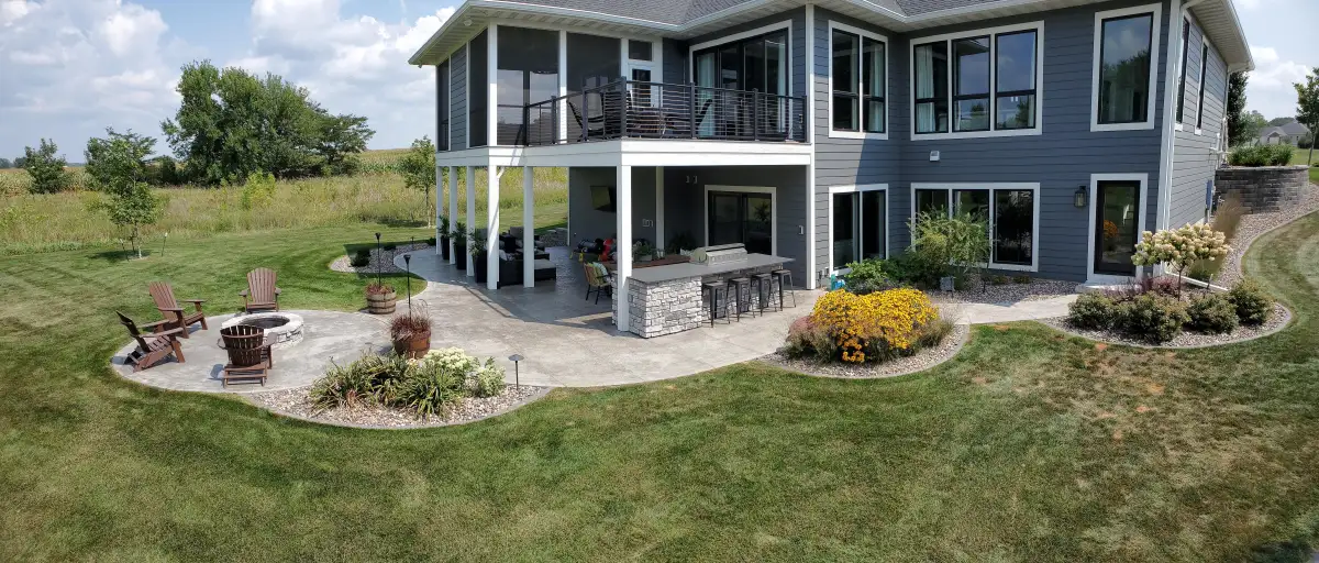 Stamped patio with outdoor bar island and fire pit seating area