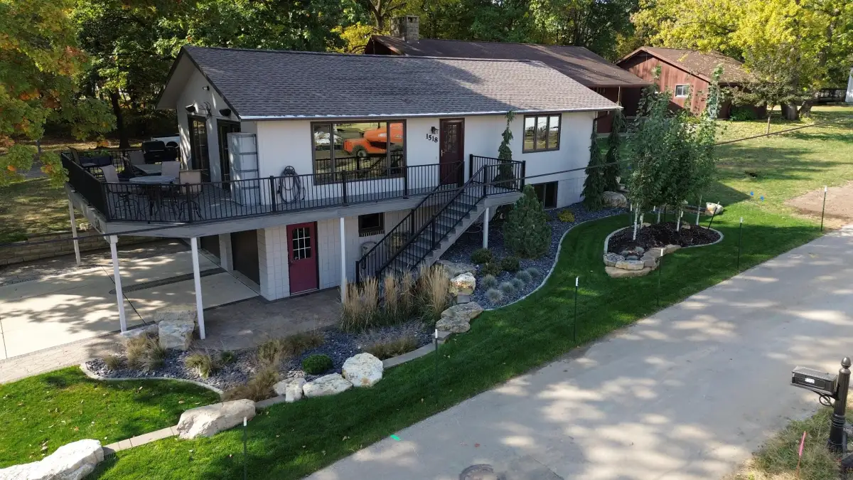 Aerial view of curved paver patio with landscaping in Iowa