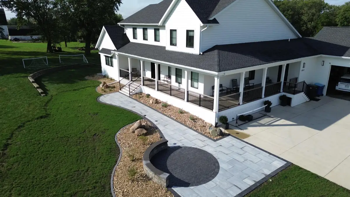 Farmhouse fire pit area with boulders and rock bed landscaping
