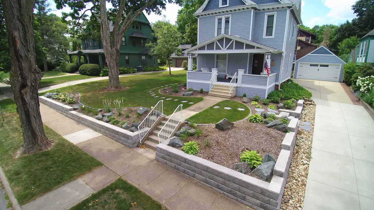 Victorian home with block retaining wall and tiered planting beds