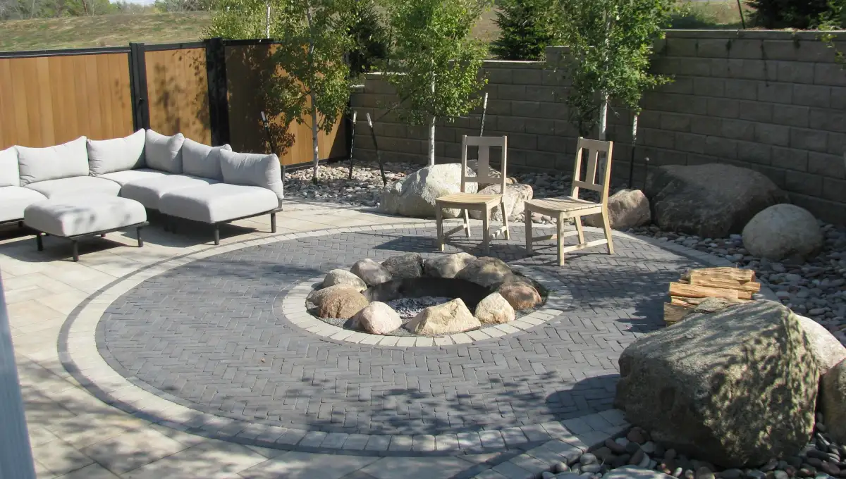 Custom stone fire pit with seating area built by Matthias Landscaping