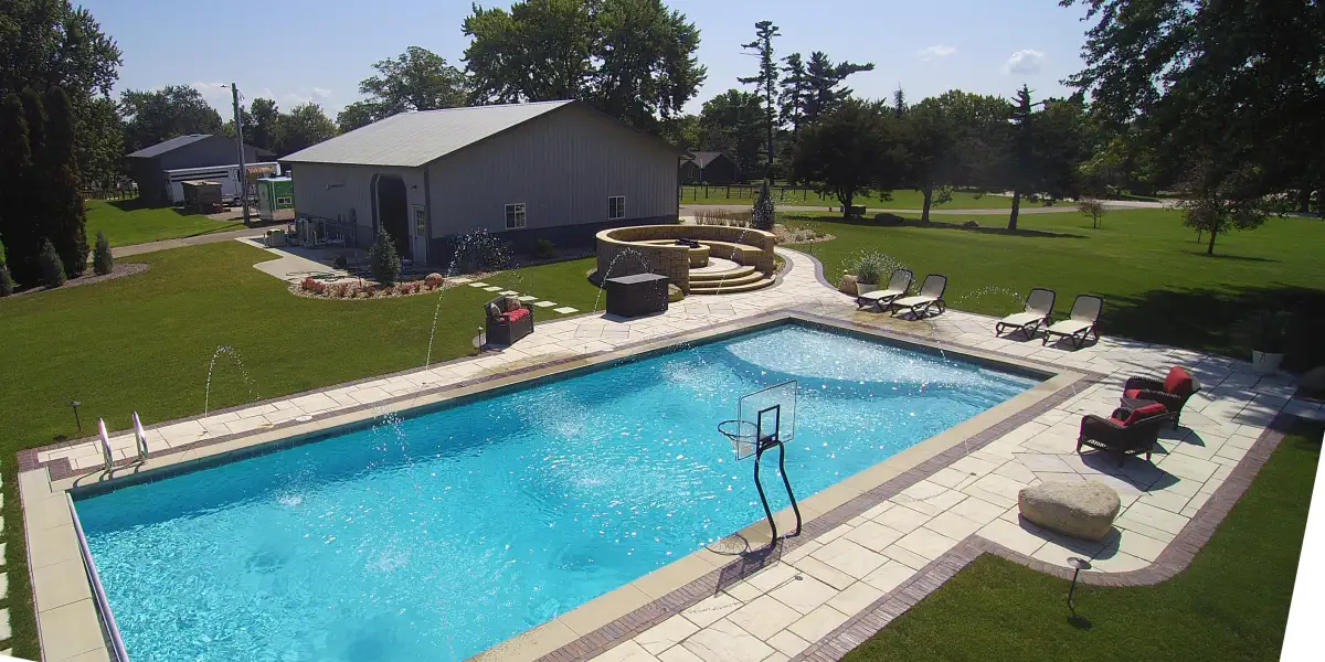 Pool area with paver surround, water features, and fire pit