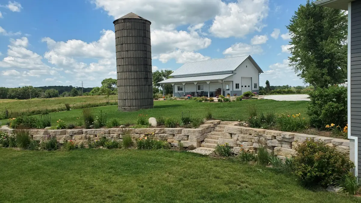 Rosetta outcropping stone retaining wall with integrated steps and perennial plantings